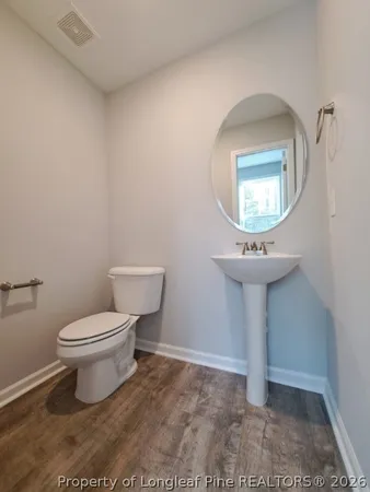 a bathroom with a sink toilet and a mirror
