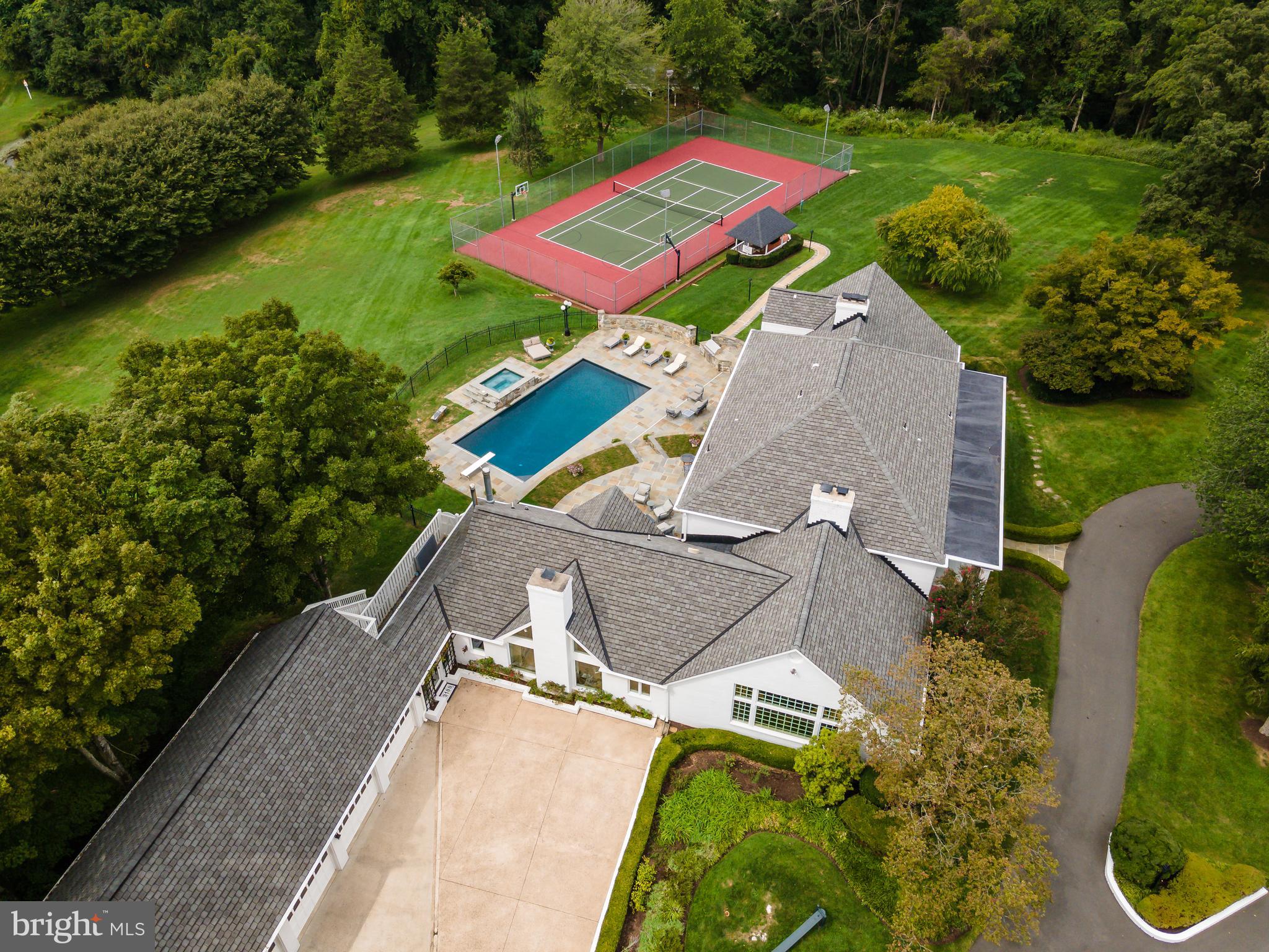 an aerial view of a house with pool outdoor seating and yard