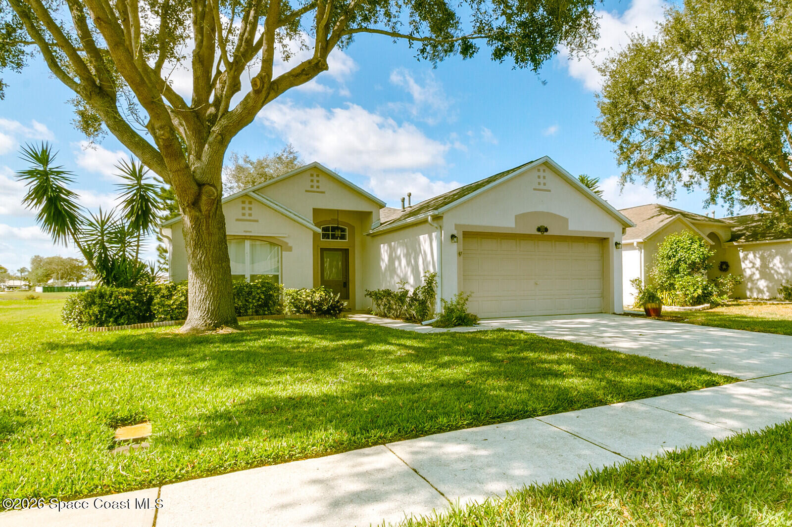 2152 Spring Creek Circle Palm Bay, FL 32905 - Photo 1 of 24 a front view of a house with a yard