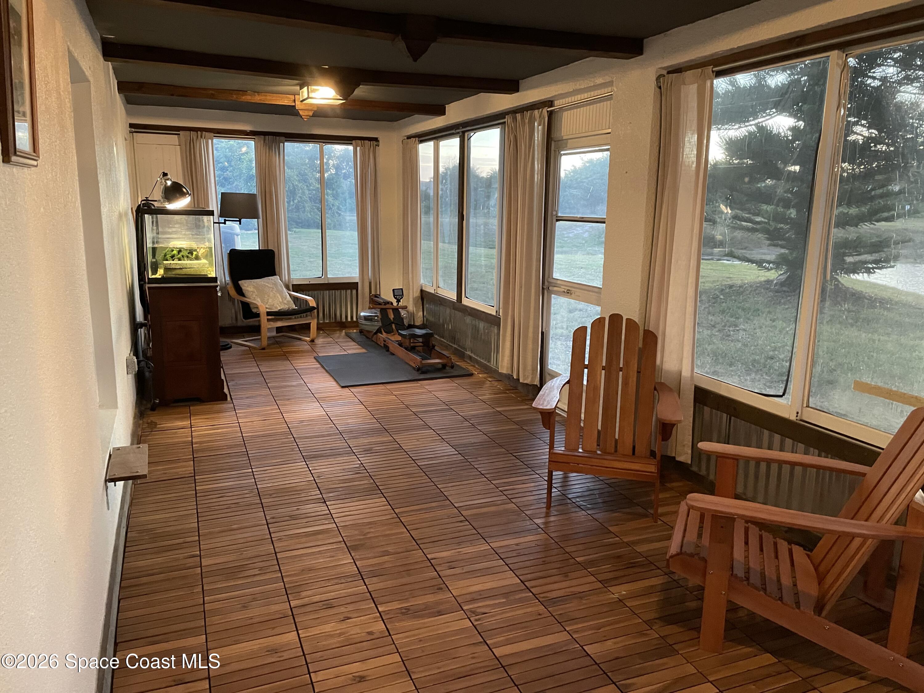 2152 Spring Creek Circle Palm Bay, FL 32905 - Photo 21 of 24 a living room with patio furniture and floor to ceiling windows