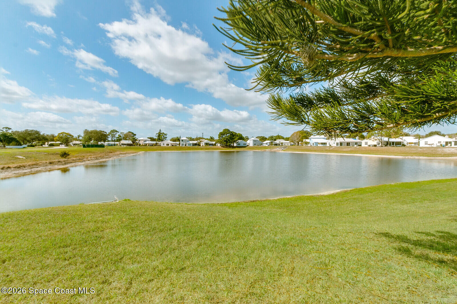 2152 Spring Creek Circle Palm Bay, FL 32905 - Photo 4 of 24 a view of a lake with houses in the background