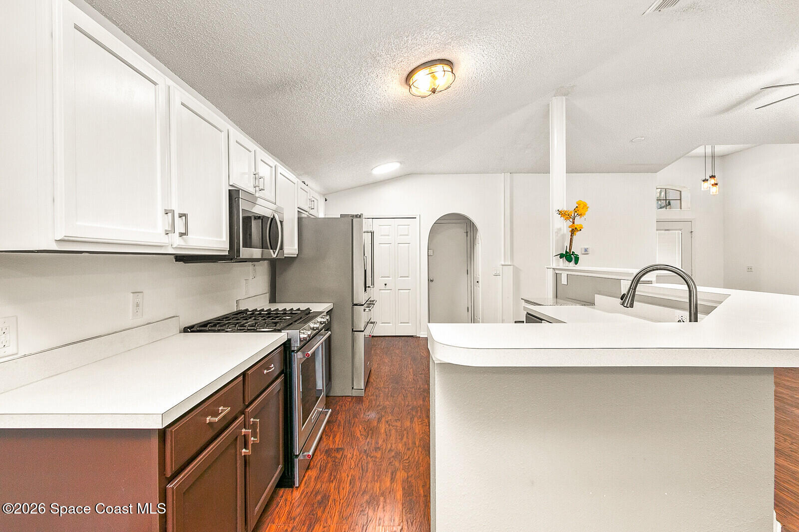 2152 Spring Creek Circle Palm Bay, FL 32905 - Photo 8 of 24 a kitchen with stainless steel appliances granite countertop a sink stove and cabinets