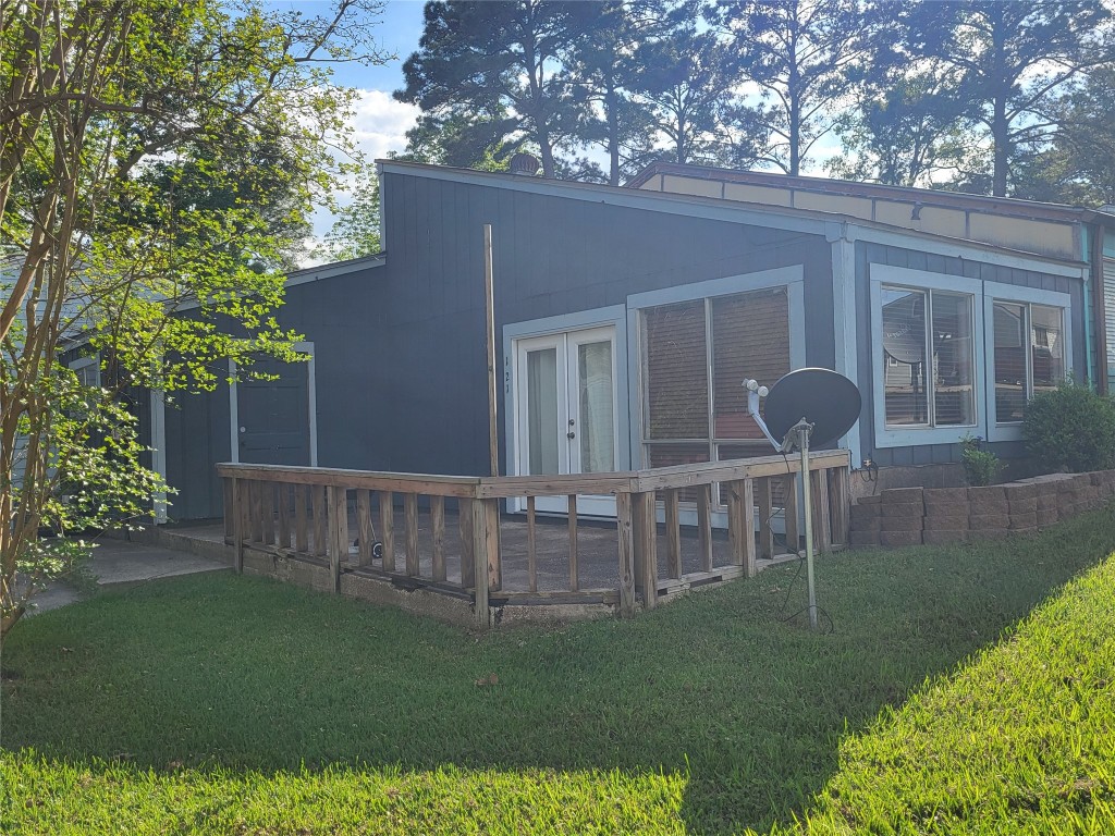 a view of house with backyard and garden