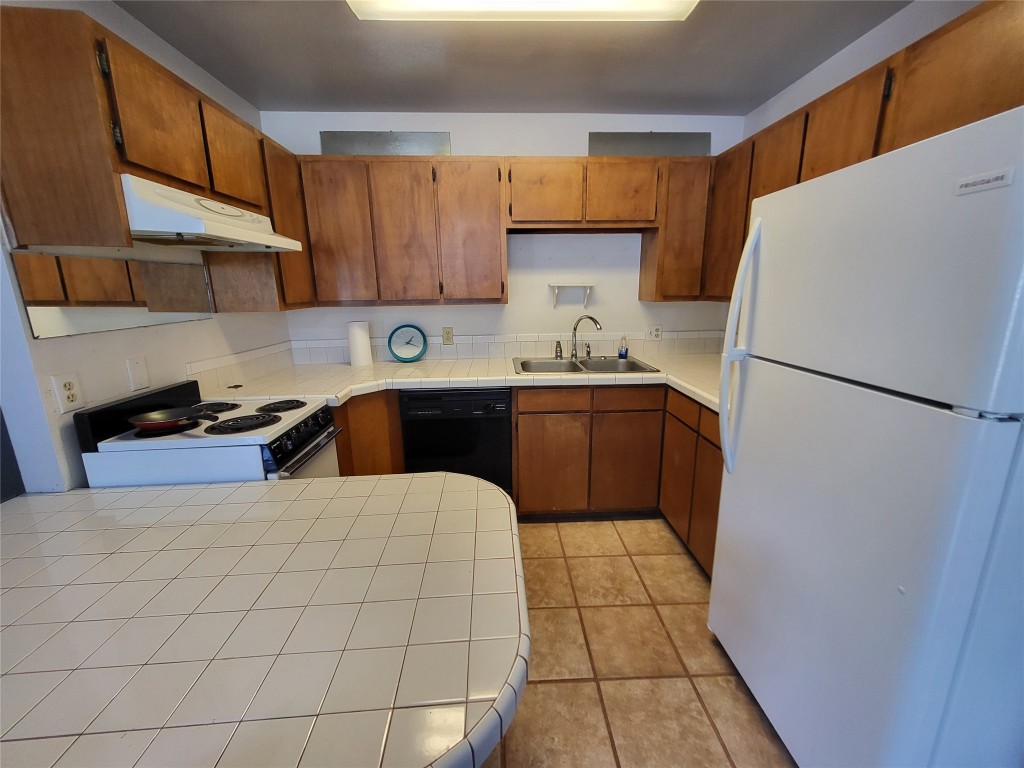 121 Harbour Lane Coldspring, TX 77331 - Photo 11 of 30 a kitchen with stainless steel appliances a refrigerator sink and cabinets