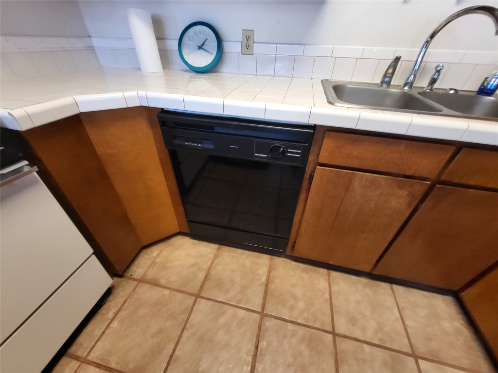 121 Harbour Lane Coldspring, TX 77331 - Photo 12 of 30 a view of a refrigerator a sink and dishwasher in a kitchen