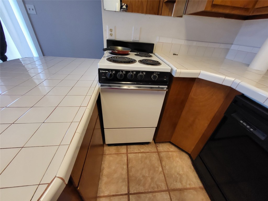 121 Harbour Lane Coldspring, TX 77331 - Photo 13 of 30 a kitchen with a stove and a refrigerator