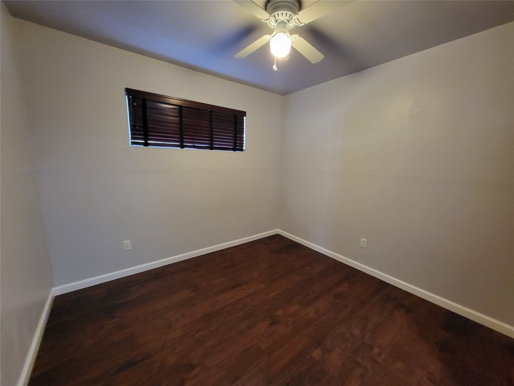 121 Harbour Lane Coldspring, TX 77331 - Photo 17 of 30 a view of an empty room with wooden floor and a ceiling fan