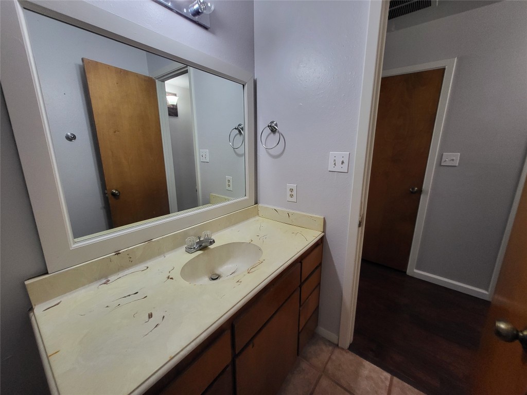 121 Harbour Lane Coldspring, TX 77331 - Photo 22 of 30 a bathroom with a sink a mirror and a toilet