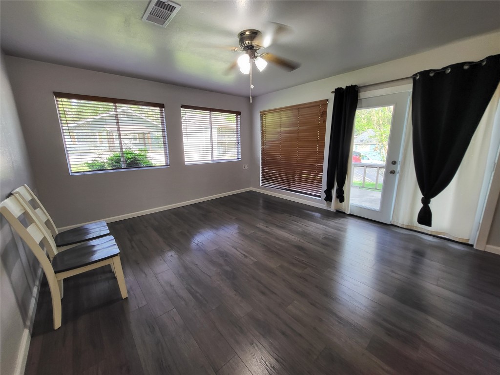 121 Harbour Lane Coldspring, TX 77331 - Photo 5 of 30 a view of a livingroom with wooden floor and a ceiling fan