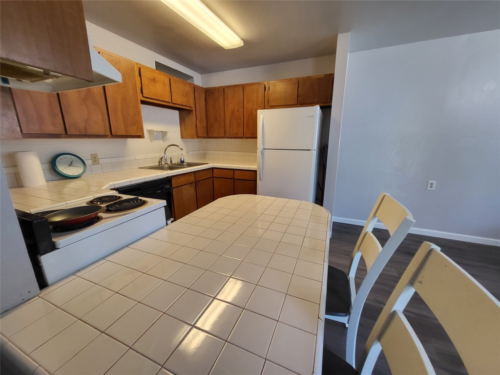 121 Harbour Lane Coldspring, TX 77331 - Photo 10 of 30 a kitchen with a refrigerator and a stove top oven