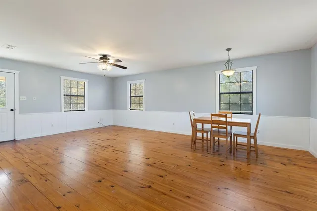 a view of a livingroom with furniture wooden floor and chandelier