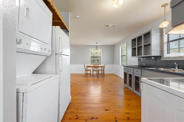 a kitchen with stainless steel appliances granite countertop a refrigerator a stove and a sink with cabinets