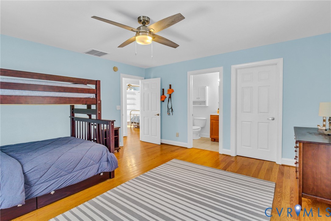 43 Ruddy Duck Road Heathsville, VA 22473 - Photo 18 of 46 a bedroom with a bed and a chandelier