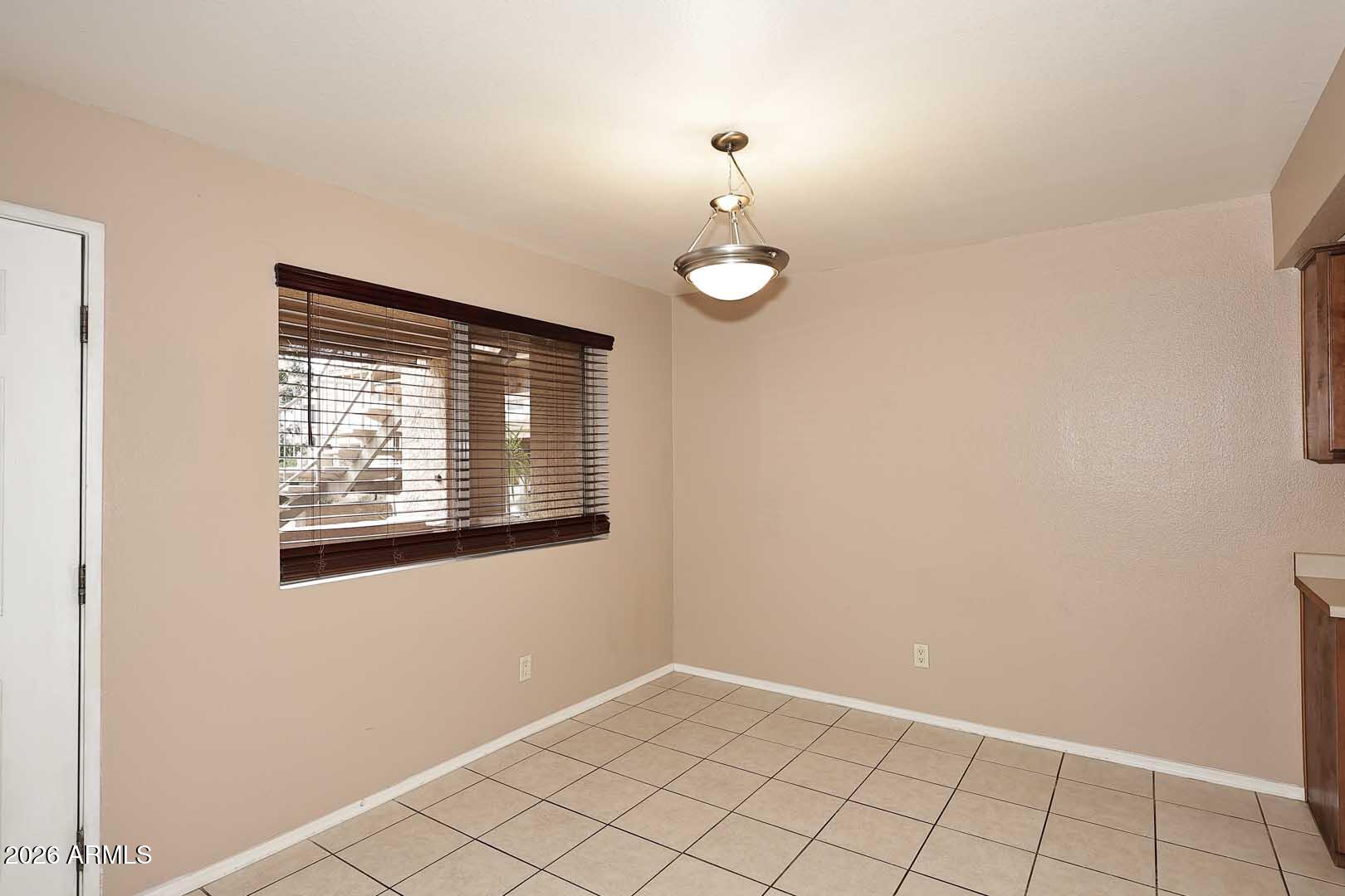303 North Miller Road, Unit 1007 Scottsdale, AZ 85257 - Photo 12 of 45 an empty room with window
