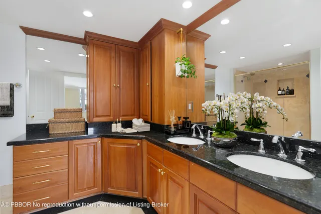 a bathroom with double vanity sinks a vanity and a mirror