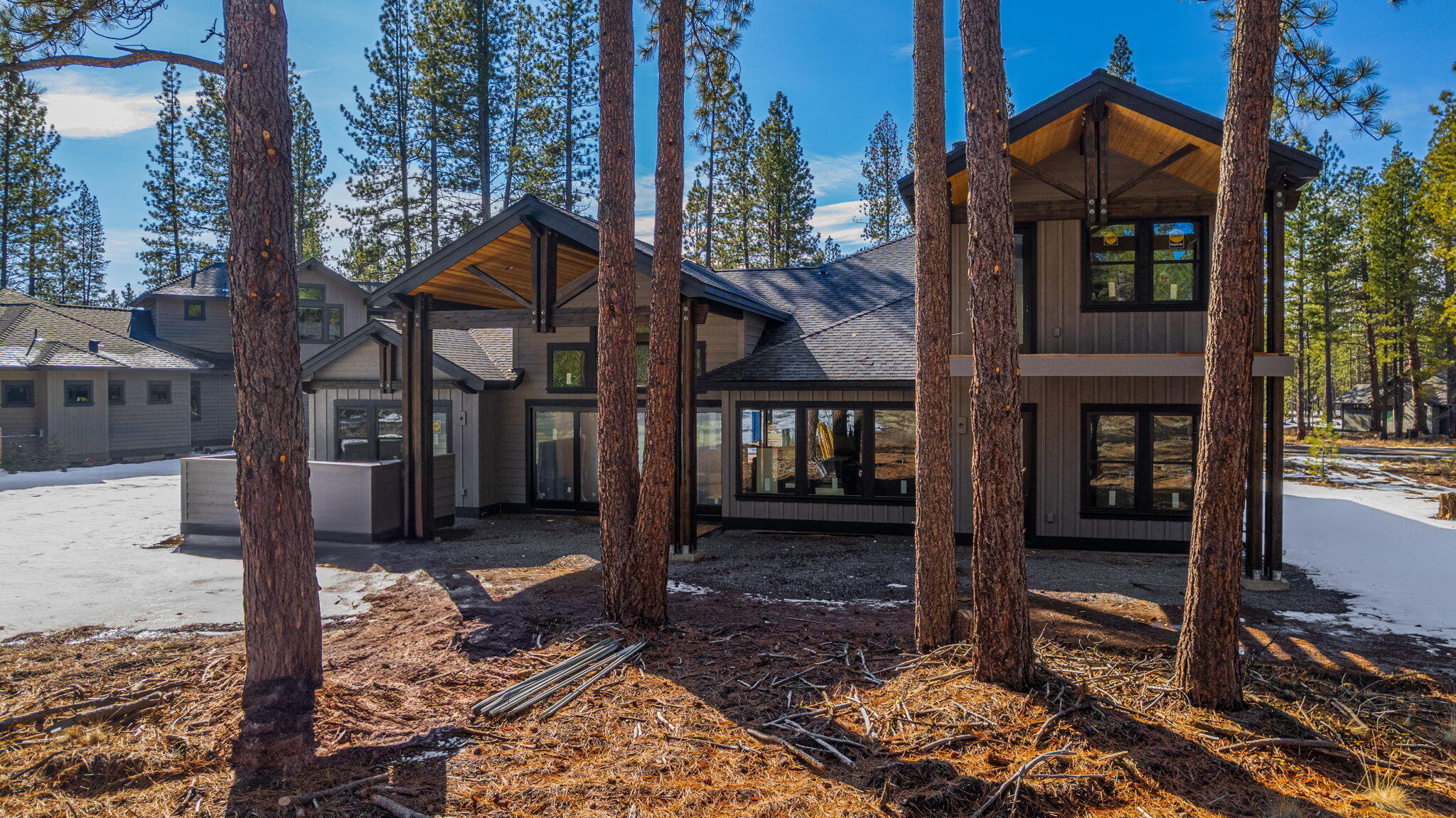 56337 Mirror Rock Loop, Unit 334 Bend, OR 97707 - Photo 15 of 34 Covered outdoor living includes cozy firepit with custom rock wall seating, hot tub with privacy wall, and built in BBQ