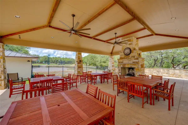 a view of a patio with table and chairs with wooden fence and floor