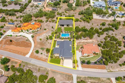 an aerial view of residential houses with yard