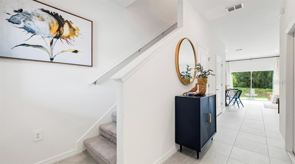 13228 Stable Place Parrish, FL 34219 - Photo 18 of 28 a view of a hallway with paintings on the wall