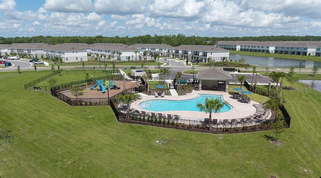 13228 Stable Place Parrish, FL 34219 - Photo 22 of 28 a swimming pool with outdoor seating and city view