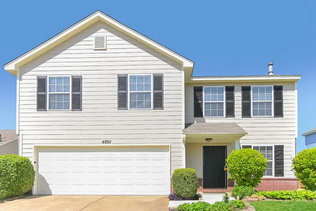 a view of house with yard