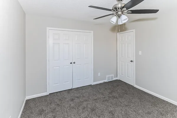 a bathroom with a toilet sink vanity and shower