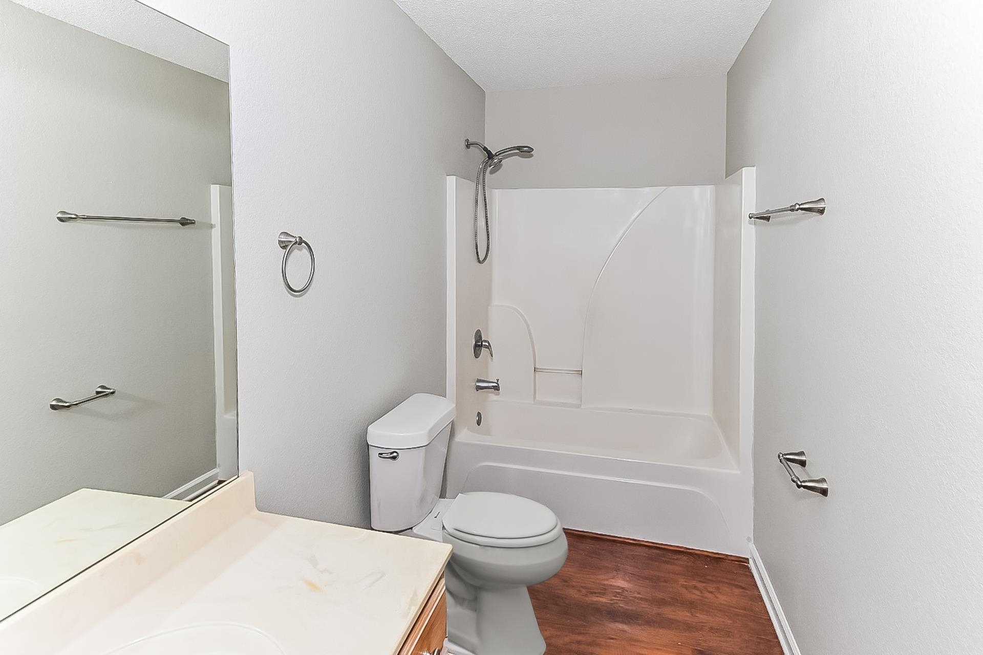 4891 Top Notch Loop Memphis, TN 38125 - Photo 14 of 17 a bathroom with a toilet sink vanity and shower