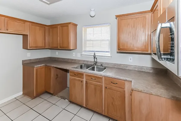 a kitchen with stainless steel appliances granite countertop a sink and a refrigerator