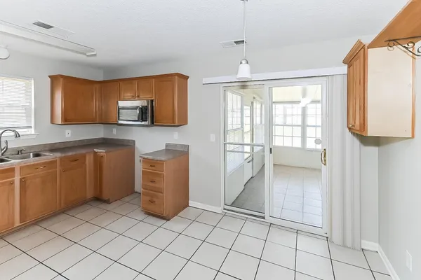 a kitchen with a sink window and cabinets