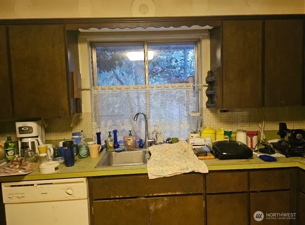 a kitchen with a sink and cabinets