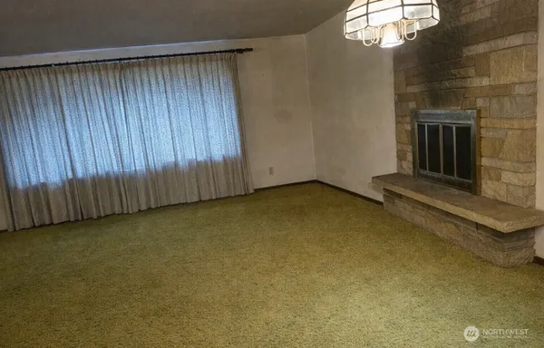 a view of an empty room and wooden floor