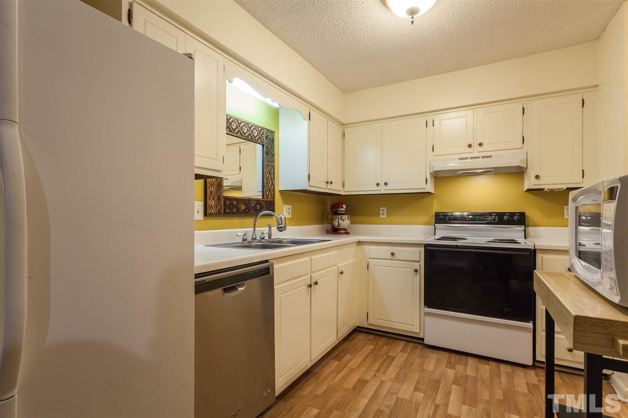 627 Pine Ridge Place, Unit NONE Raleigh, NC 27609 - Photo 11 of 21 a kitchen with a sink cabinets and stainless steel appliances