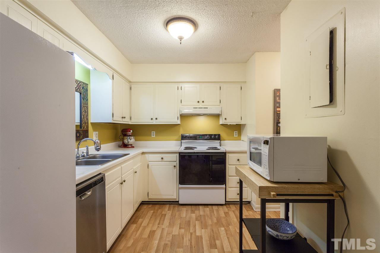627 Pine Ridge Place, Unit NONE Raleigh, NC 27609 - Photo 12 of 21 a kitchen with a sink cabinets and appliances