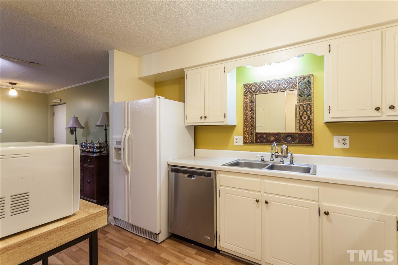 627 Pine Ridge Place, Unit NONE Raleigh, NC 27609 - Photo 13 of 21 a kitchen with a sink and refrigerator