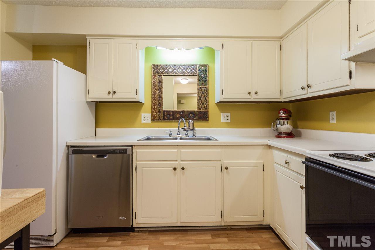 627 Pine Ridge Place, Unit NONE Raleigh, NC 27609 - Photo 14 of 21 a kitchen with stainless steel appliances granite countertop a sink stove and cabinets