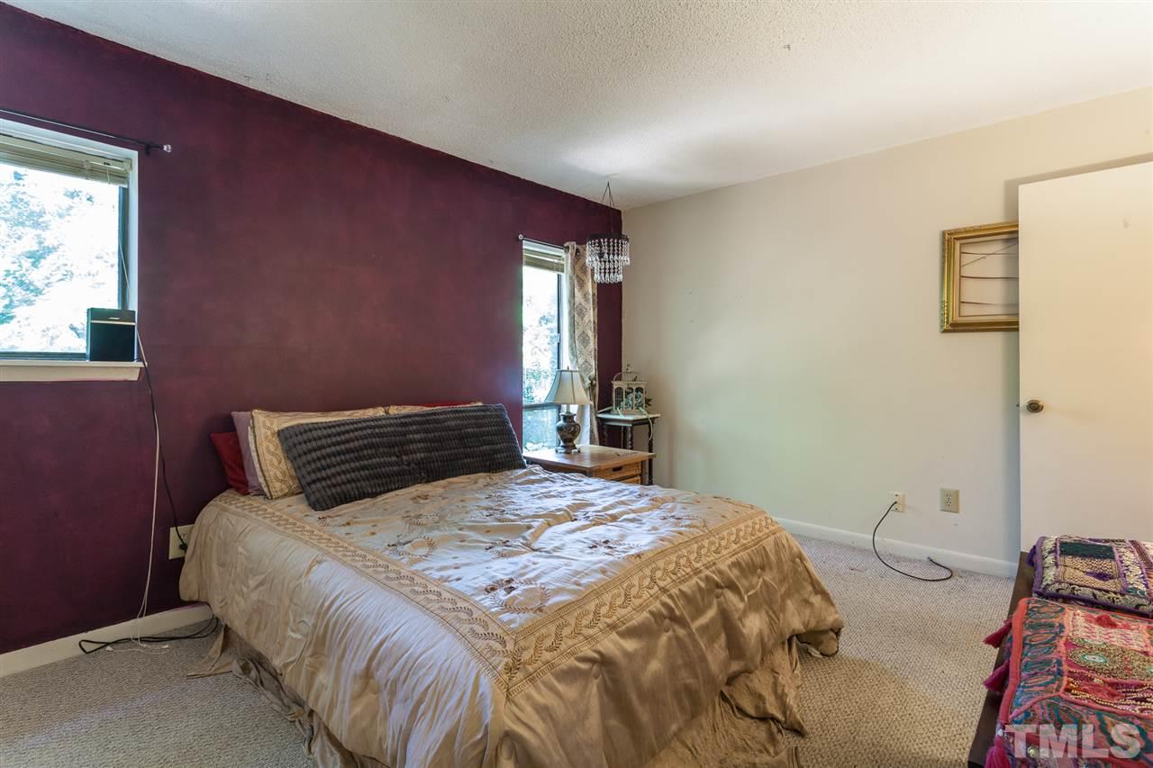 627 Pine Ridge Place, Unit NONE Raleigh, NC 27609 - Photo 18 of 21 a bedroom with a bed and a dresser next to a window