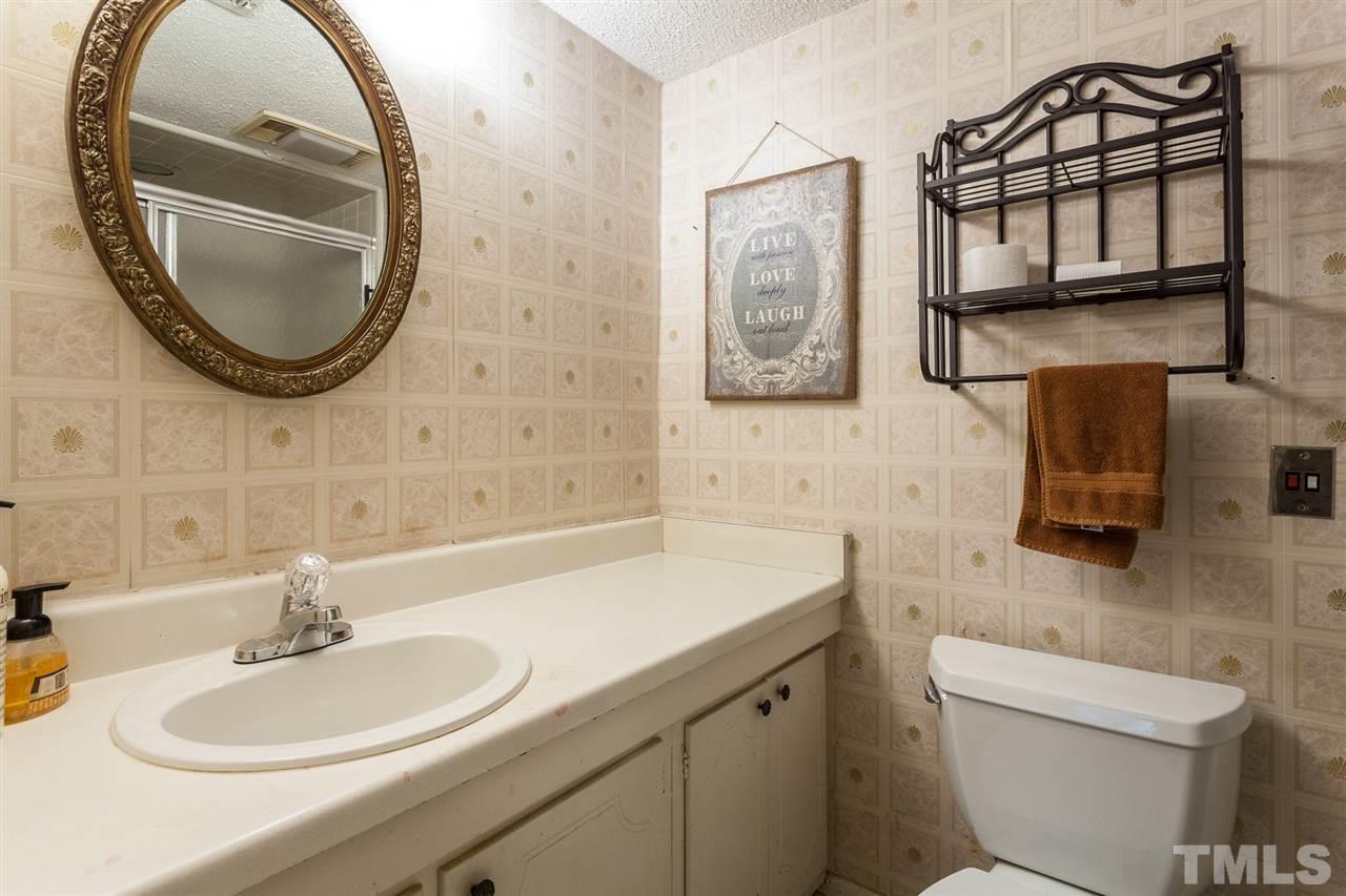 627 Pine Ridge Place, Unit NONE Raleigh, NC 27609 - Photo 19 of 21 a bathroom with a sink and a mirror