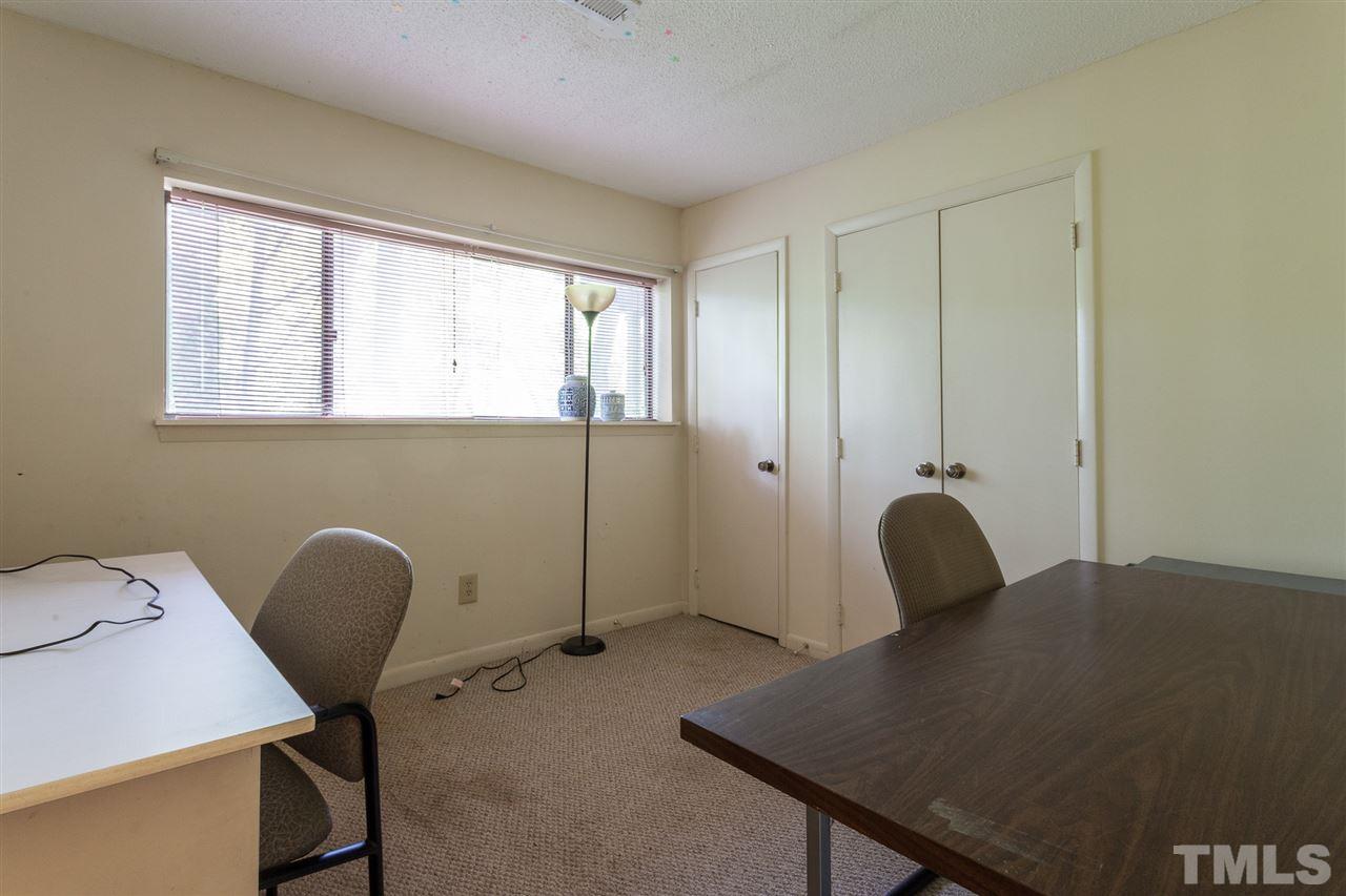 627 Pine Ridge Place, Unit NONE Raleigh, NC 27609 - Photo 20 of 21 a view of a workspace with furniture and a window