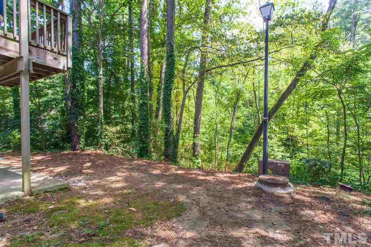 627 Pine Ridge Place, Unit NONE Raleigh, NC 27609 - Photo 3 of 21 a view of backyard with large trees