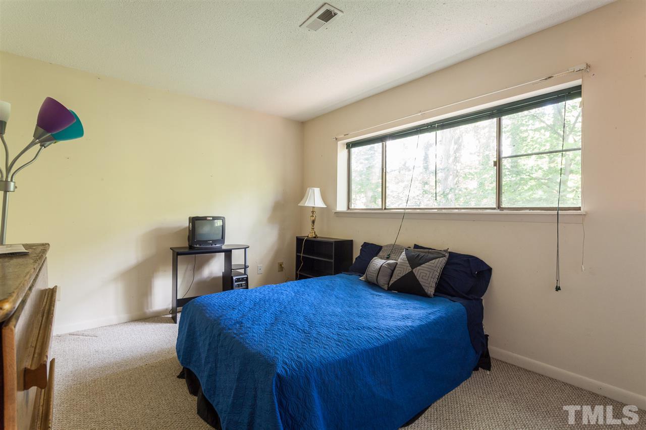 627 Pine Ridge Place, Unit NONE Raleigh, NC 27609 - Photo 21 of 21 a bedroom with a bed and window