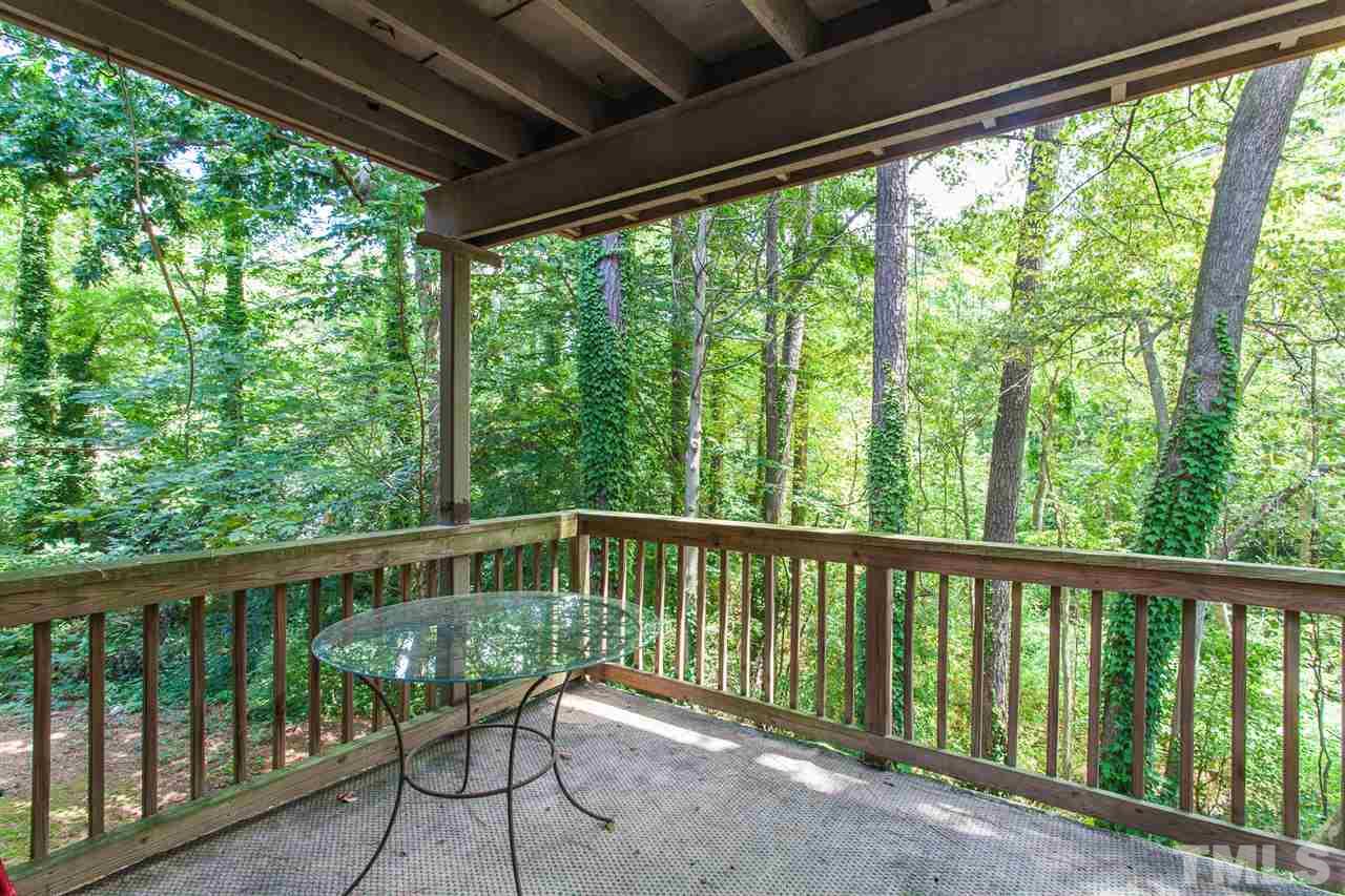 627 Pine Ridge Place, Unit NONE Raleigh, NC 27609 - Photo 5 of 21 a view of a wooden deck next to a yard
