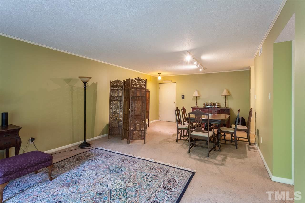 627 Pine Ridge Place, Unit NONE Raleigh, NC 27609 - Photo 9 of 21 a living room with furniture and a rug