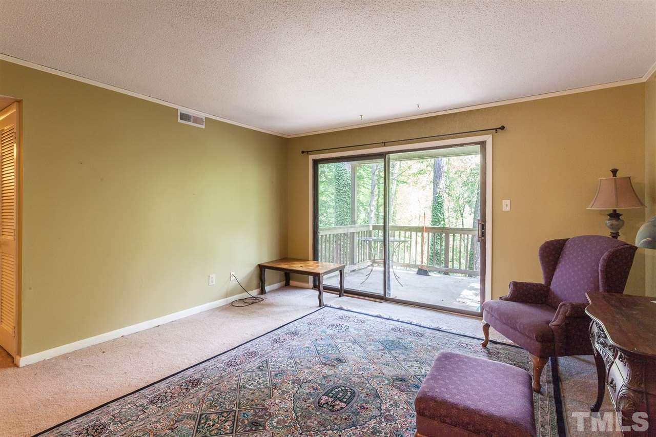 627 Pine Ridge Place, Unit NONE Raleigh, NC 27609 - Photo 10 of 21 a living room with furniture and a window