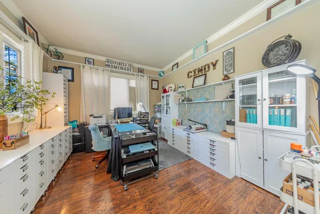 a kitchen with a sink cabinets and wooden floor