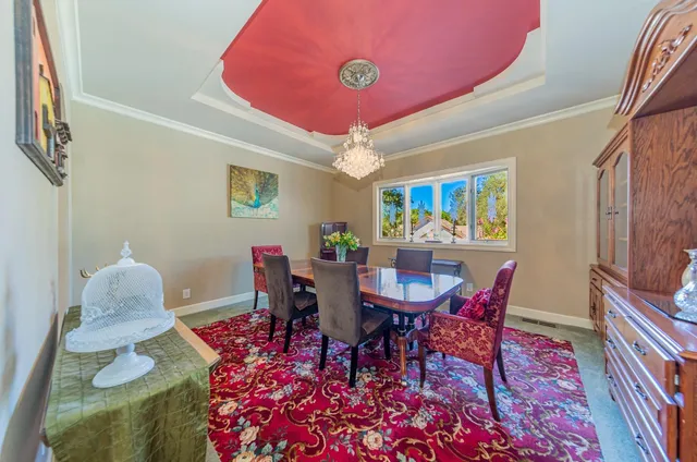 a view of a hallway with a dining table and chairs
