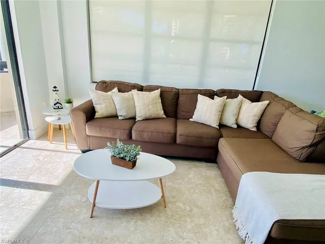a living room with furniture and a rug
