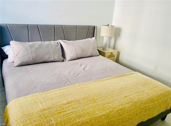 a bedroom with a bed and a couch