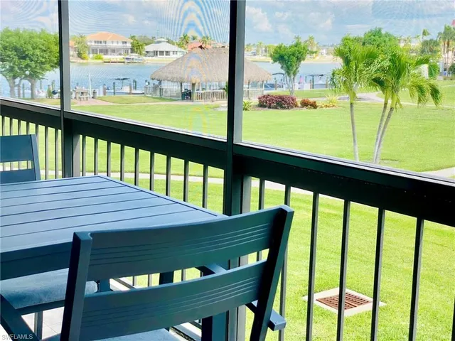 a view of a two chairs in the balcony