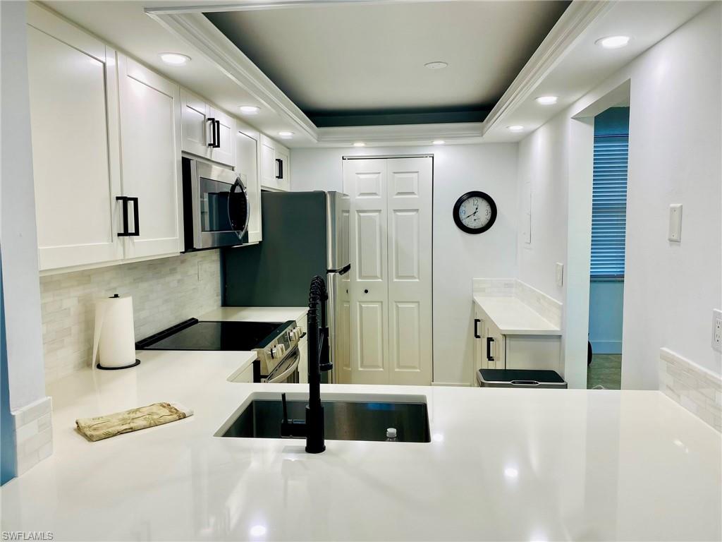 601 Seaview Court, Unit C208 Marco Island, FL 34145 - Photo 3 of 16 a bathroom with a sink a mirror and a shower