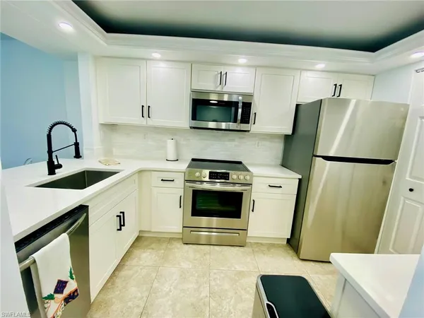 a kitchen with a sink a stove and refrigerator